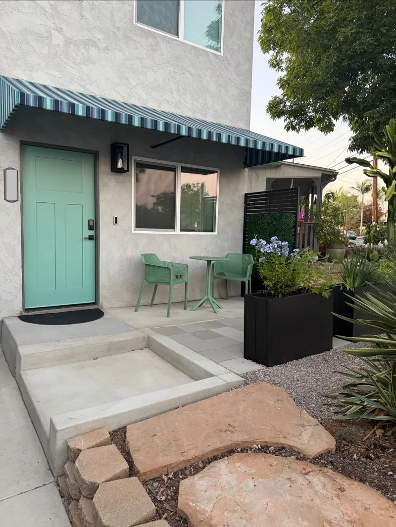 Boundary entrance and outdoor patio beside the new building