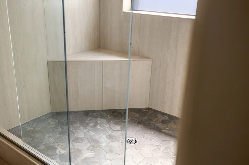 Built-in shower bench beside the window