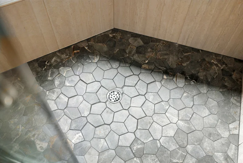 Hexagonal shower floor tile and drain