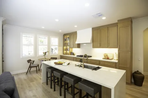 Picket Fence kitchen with wood cabinets and white island
