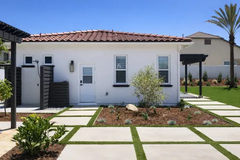 Finished Via Santa exterior with tile roof and landscaped walkway
