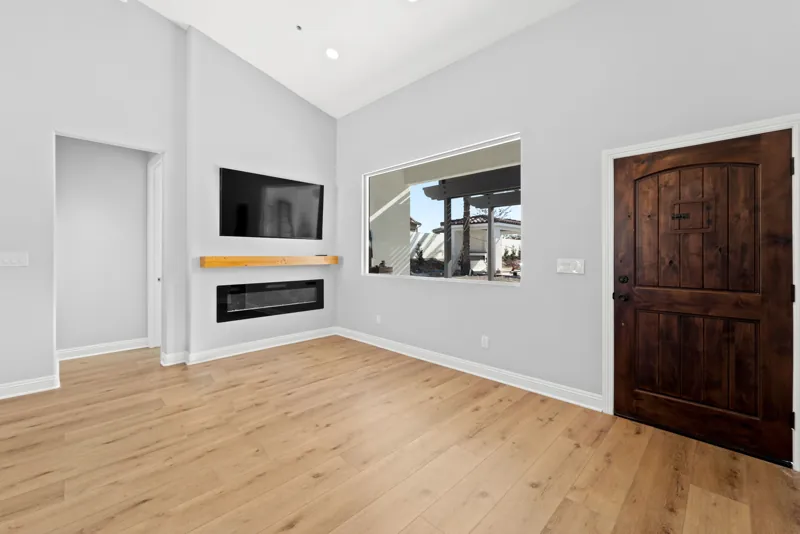 Living space with fireplace and wood flooring